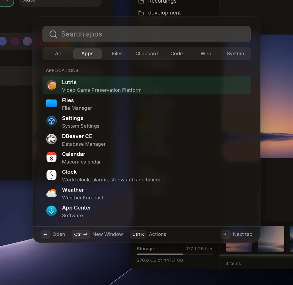 The launcher on its Apps tab, over blurred windows